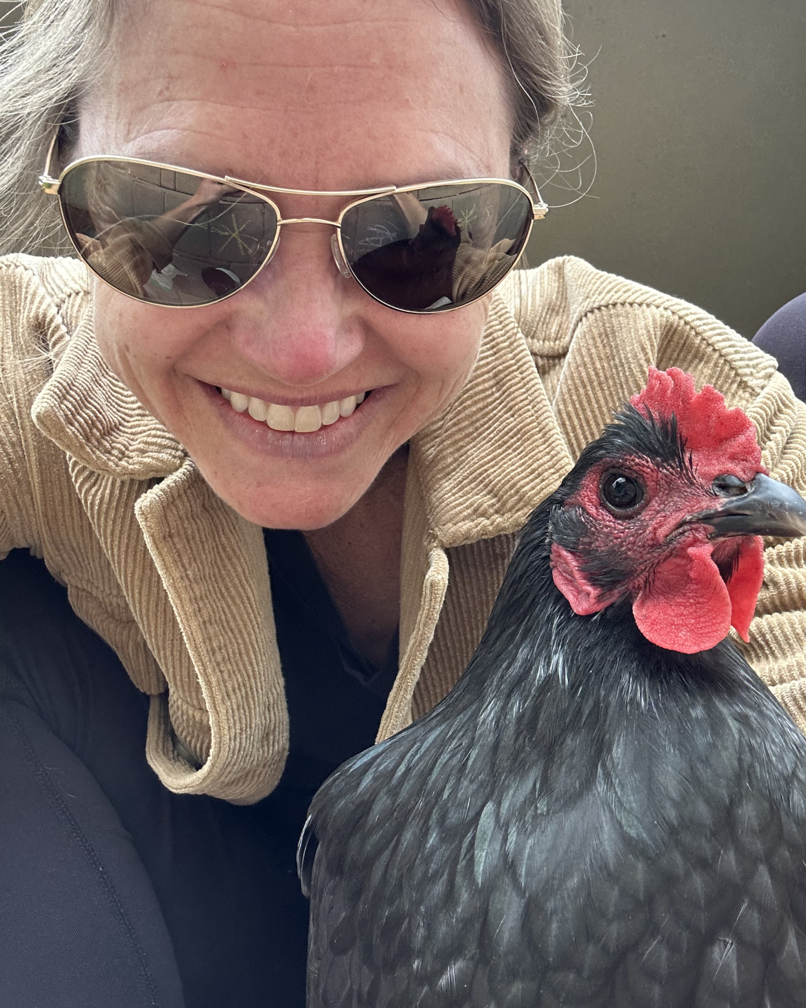 Sage Mercer with a hen from her flock